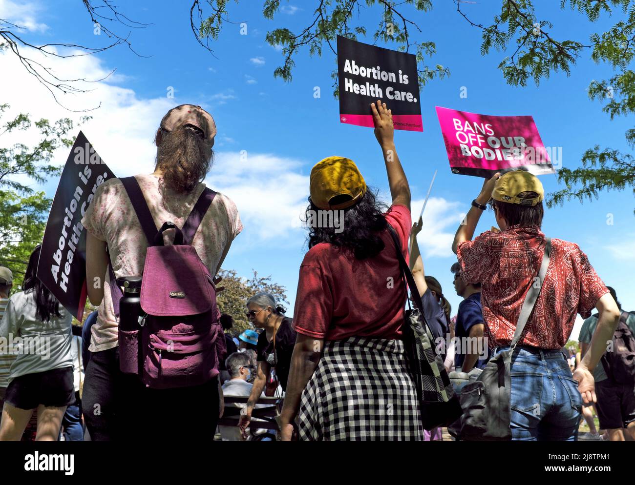 Tre donne si levano in ombra durante un raduno dei diritti di aborto il 14 maggio 2022 a Cleveland, Ohio, USA. Foto Stock