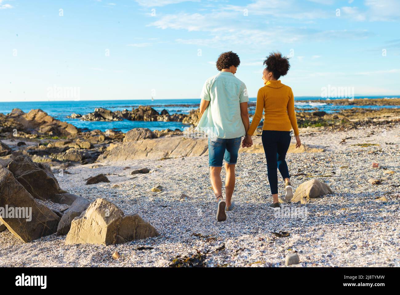 Amorevole giovane coppia afroamericana che tiene le mani mentre cammina alla spiaggia, spazio copia Foto Stock