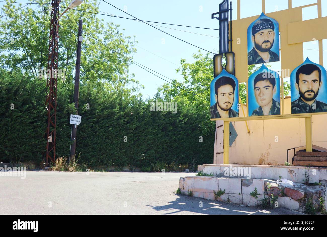 La foto dei martiri di Hezbollh si trova a Nabatieh, Libano meridionale, maggio 19 2022. Il leader di Hezbollah, Hassan Nasrallah, ha dichiarato il 18 maggio in un discorso televisivo sul risultato delle elezioni che “nessun campo politico nel Paese può pretendere di avere una chiara maggioranza parlamentare”. Nasrallah ha spiegato che “non è vero che la maggioranza si è spostata da un luogo all’altro” e che i sostenitori di Hezbollah “hanno ottenuto una vittoria molto grande e dobbiamo esserne orgogliosi alla luce delle circostanze della battaglia”. Nasrallah ha sottolineato che “la resistenza e i suoi alleati hanno una forte e grande presenza nel nuovo parlamento. Foto Stock