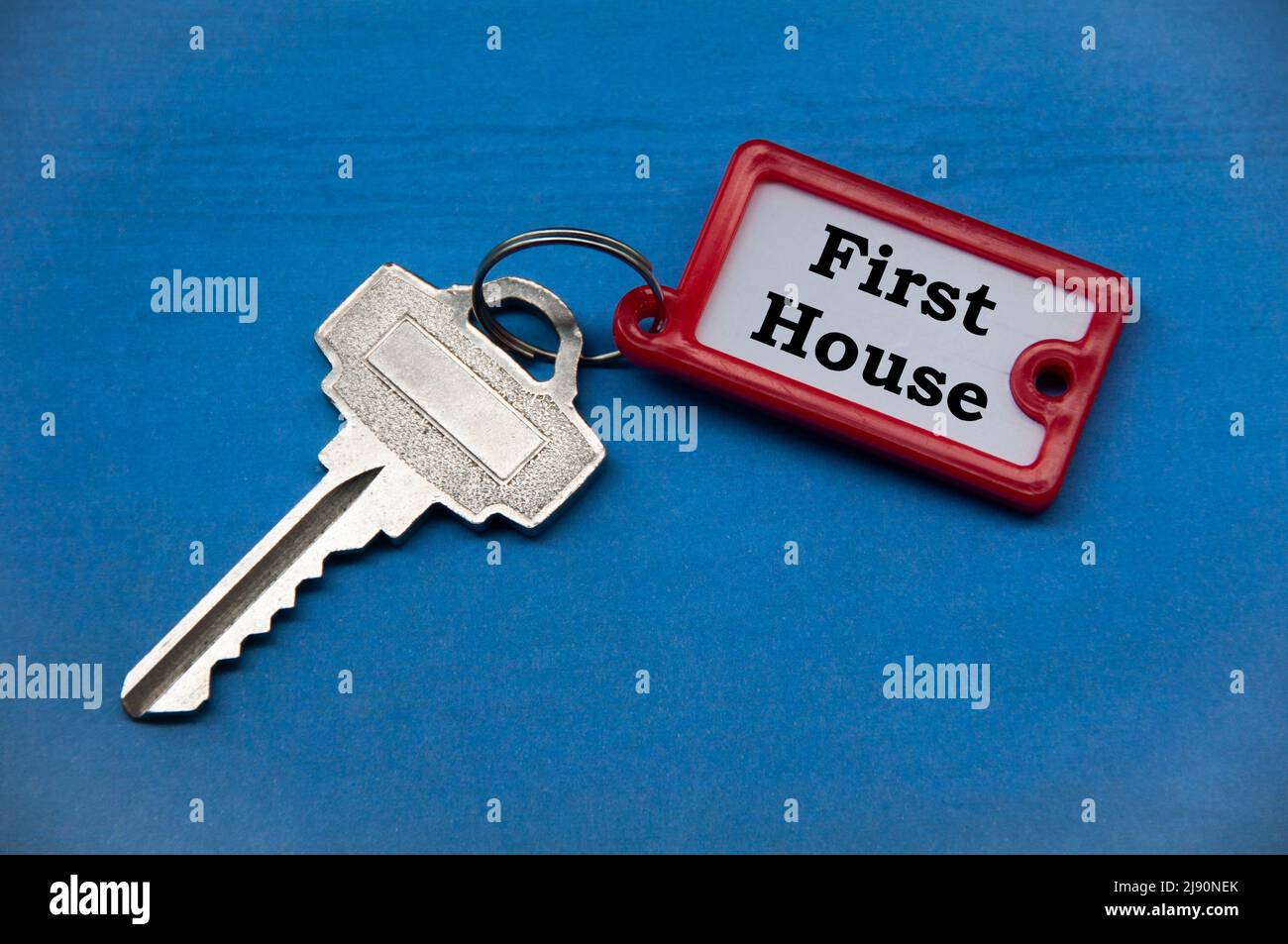 Testo della prima casa sulla portachiavi. Investimento immobiliare e concetto di business. Foto Stock