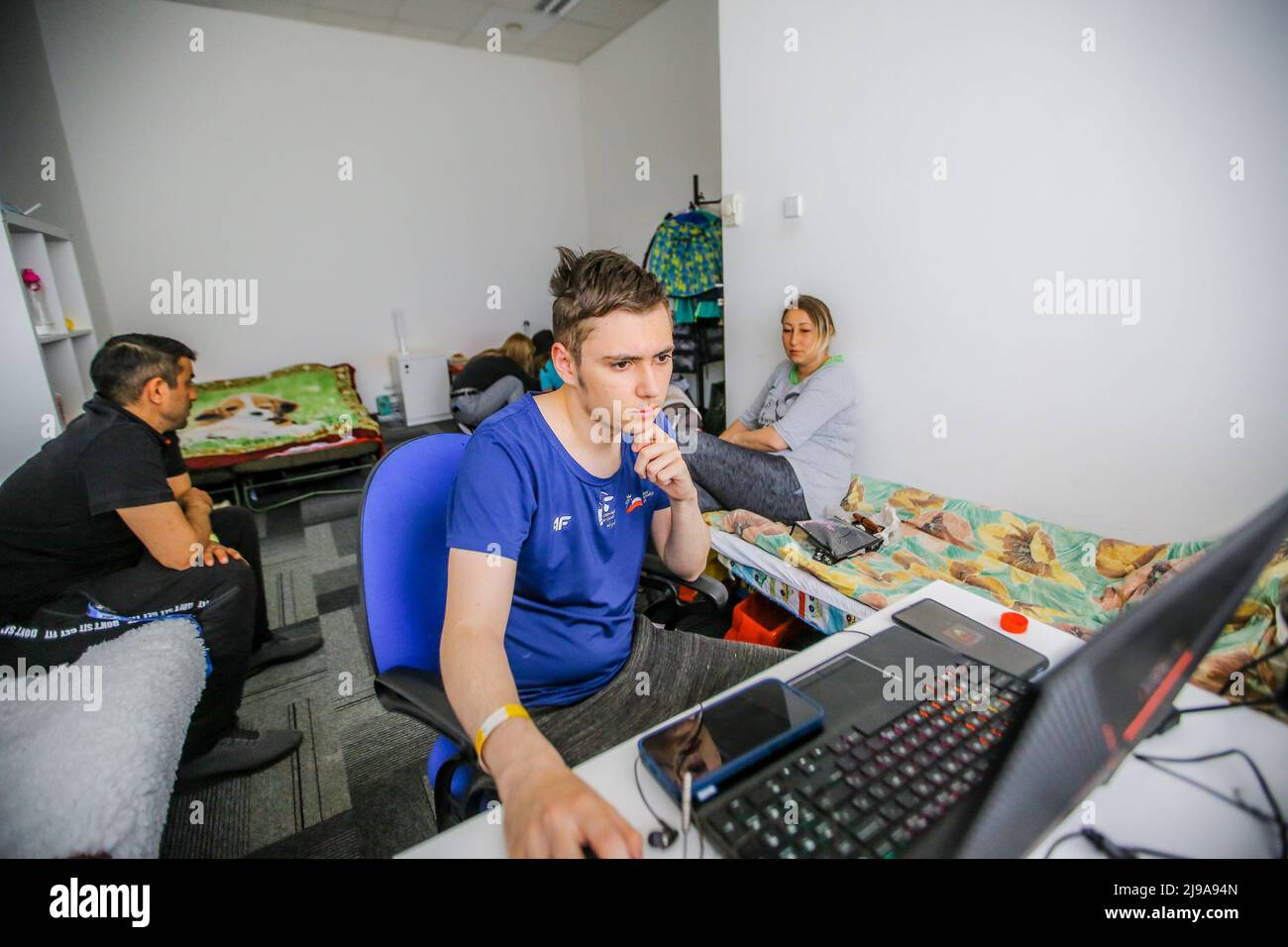 Un giovane usa un computer in un rifugio per rifugiati a Varsavia. I rifugiati che vivevano nel campo arrivarono a Varsavia il 24 febbraio, quando scoppiò la guerra. Attualmente nel campo ci sono circa 900 rifugiati. Questi rifugiati provenivano da diverse città ucraine. Ogni giorno vengono forniti di cibo, medicine e vestiti. Dopo il ritiro dell'esercito russo da diverse città ucraine, alcuni rifugiati tornano a casa. La Russia ha invaso l'Ucraina il 24 febbraio 2022, scatenando il più grande attacco militare in Europa dalla seconda guerra mondiale Foto Stock