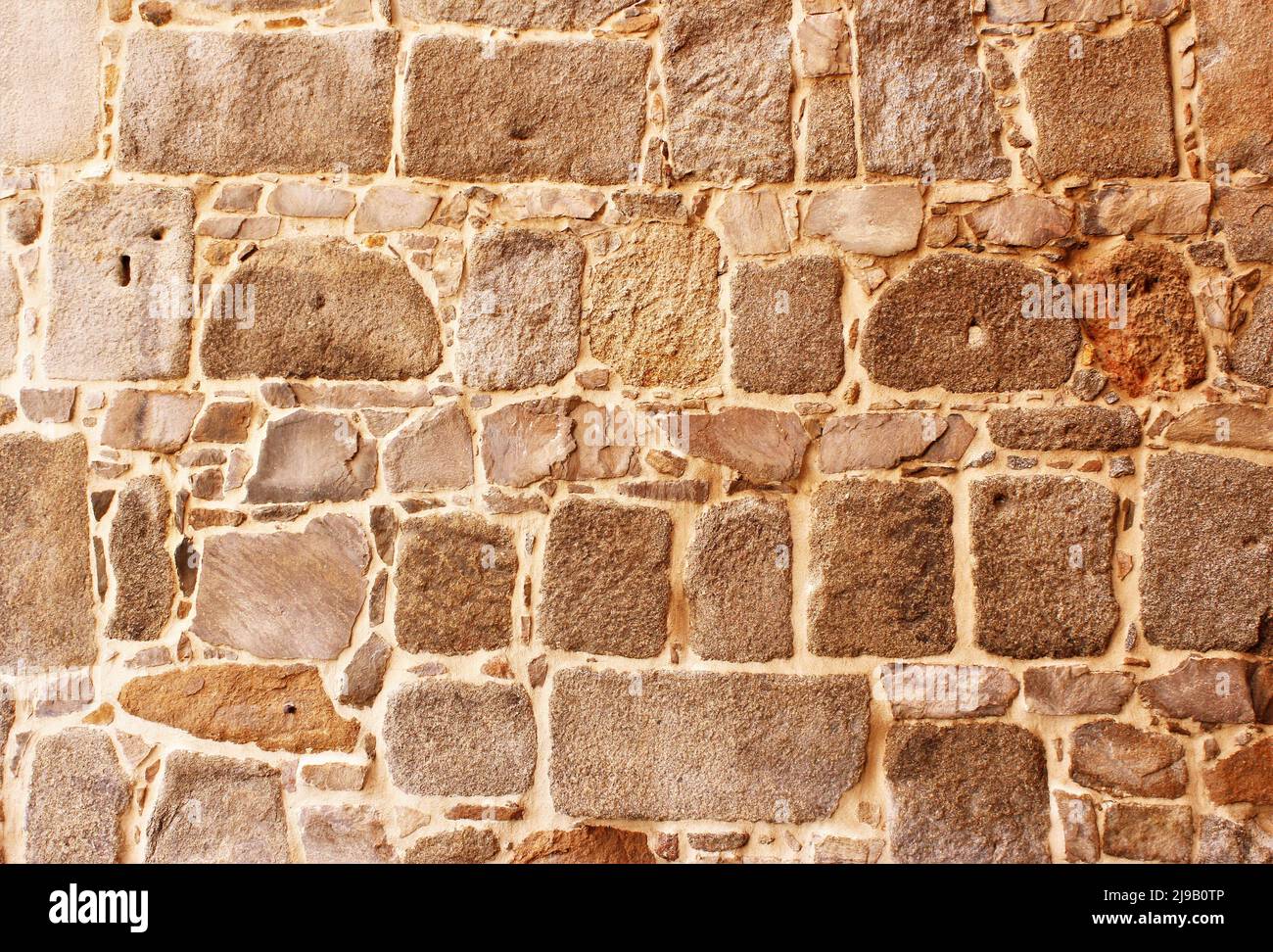 Vecchio muro fatto da pietre texture sfondo foto full frame Foto Stock