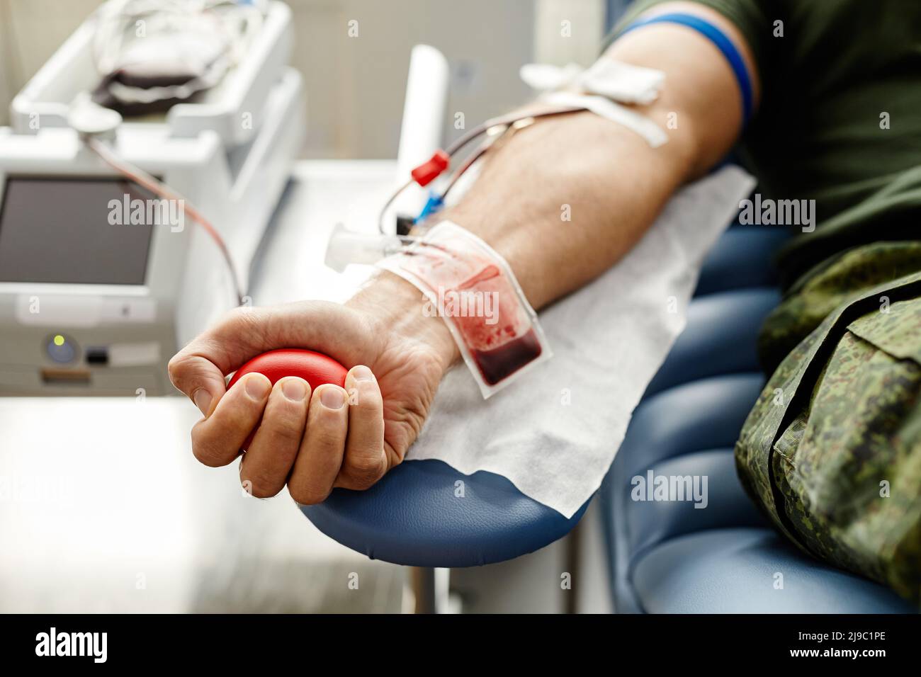 Primo piano di mano maschile con sacco di sangue al centro di donazione di sangue, spazio copia Foto Stock