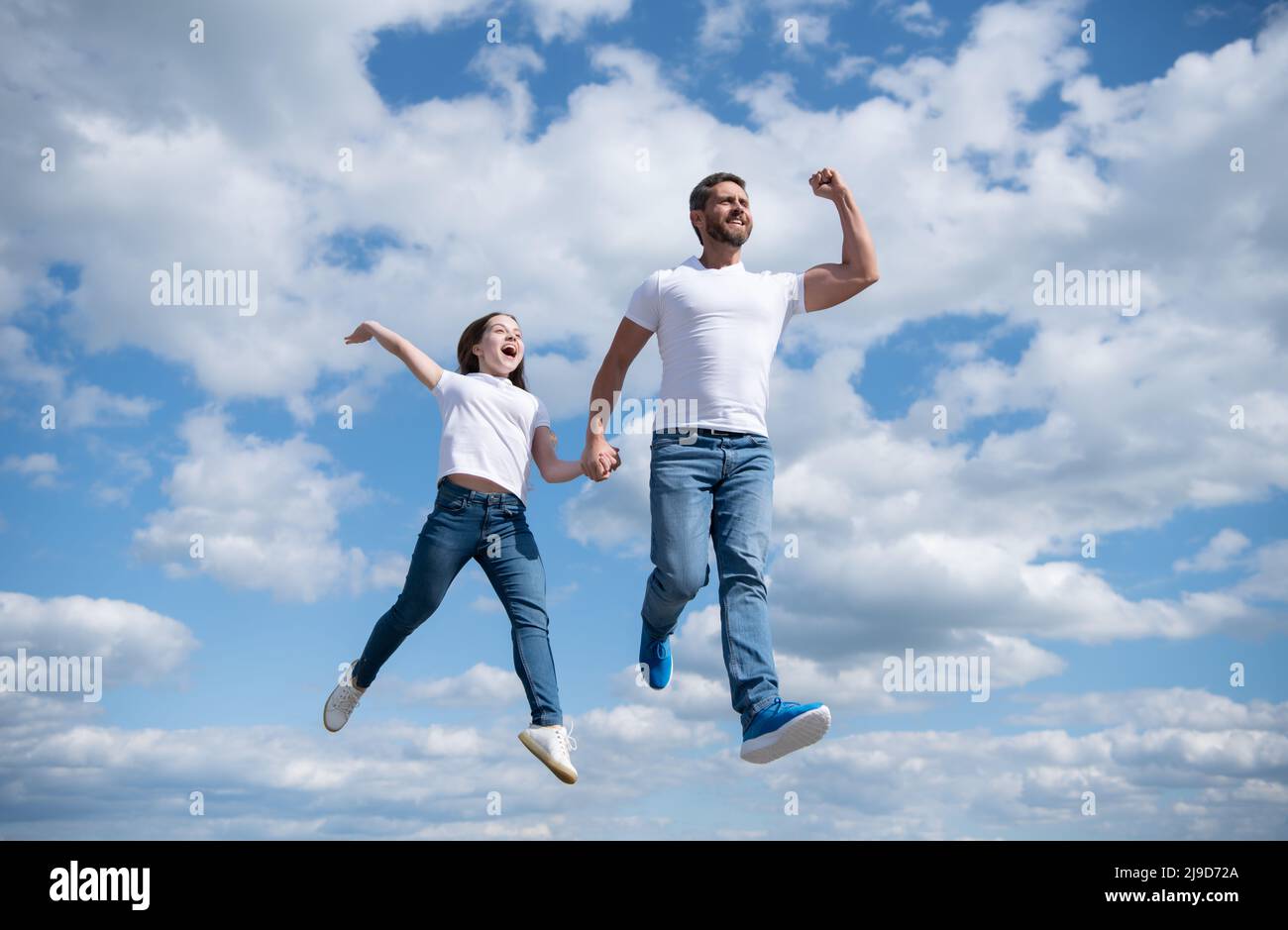 felice padre e figlia saltare in cielo. libertà Foto Stock