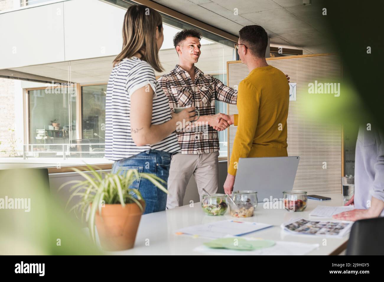 Due imprenditori stringono le mani in office Foto Stock