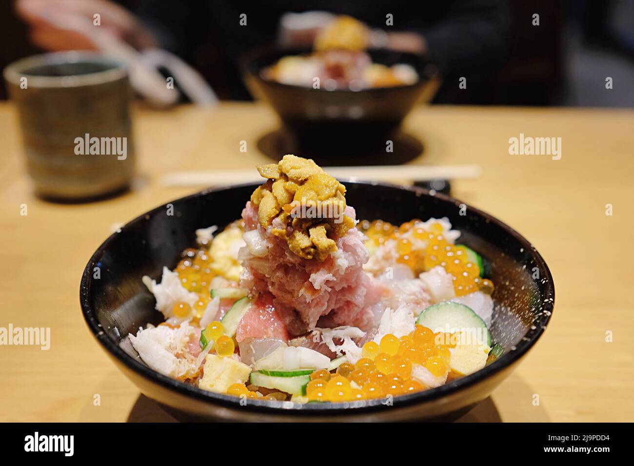 Chirashi-don: Una ciotola di riso, sashimi, uni (riccio di mare) e altri tipi di pesce fresco in un ristorante omakase a Shinjuku - Tokyo, Giappone Foto Stock