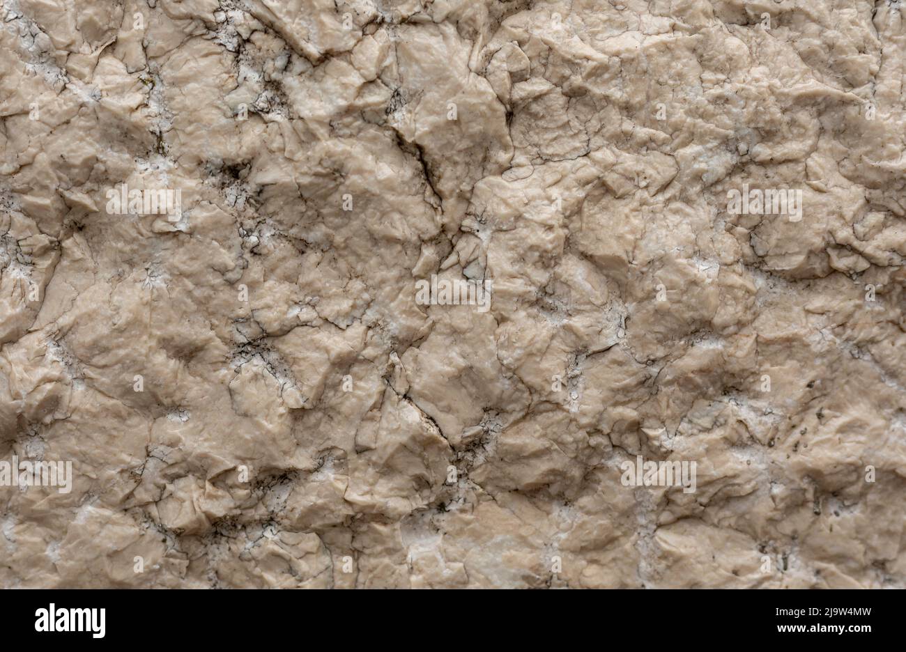 Sfondo di pietra sconnessa color crema con crepe a fessure Foto Stock