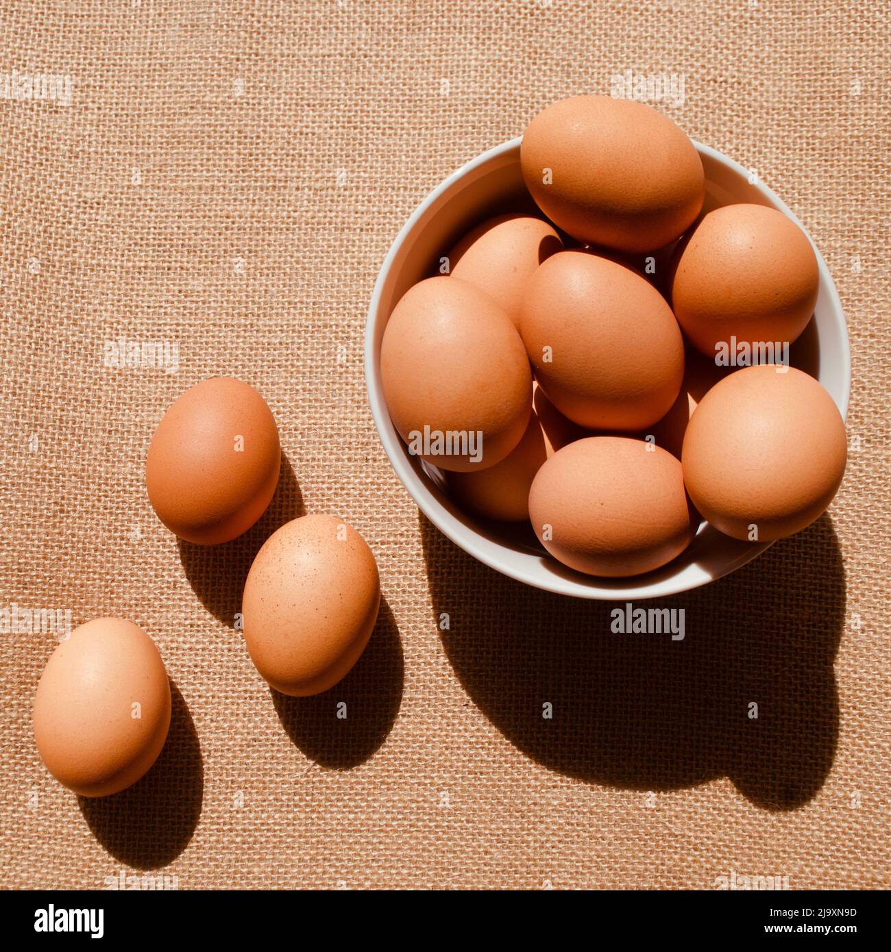 Uova su sacco marrone su sfondo scuro Foto Stock