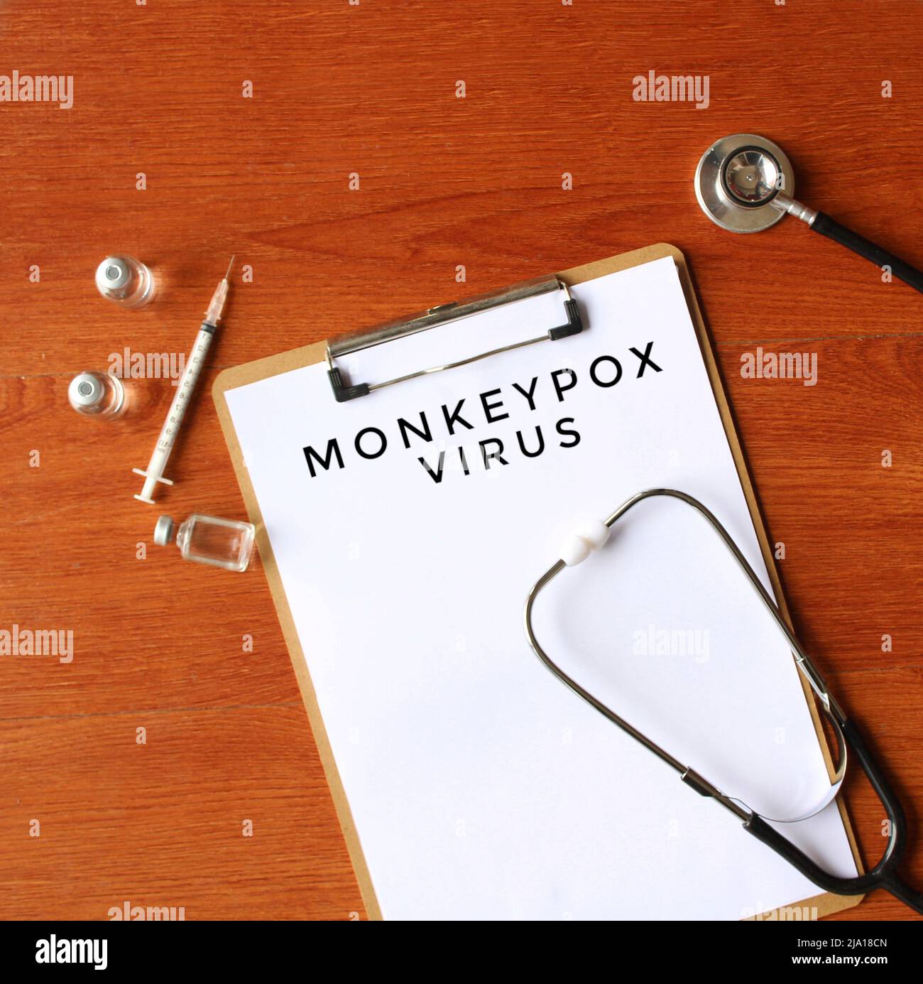 Immagine vista dall'alto di stetoscopio, fiala di vetro e carta con testo VIRUS MONKEYPOX. Concetto medico. Foto Stock