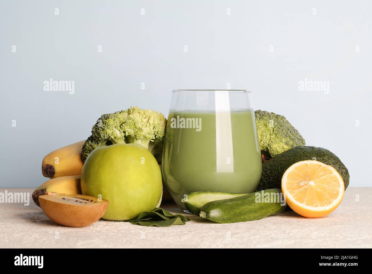 Frullato verde fresco in vetro con verdure su sfondo blu. Cibo vegano, lifestyle sano.sano detox dieta copia spazio Foto Stock