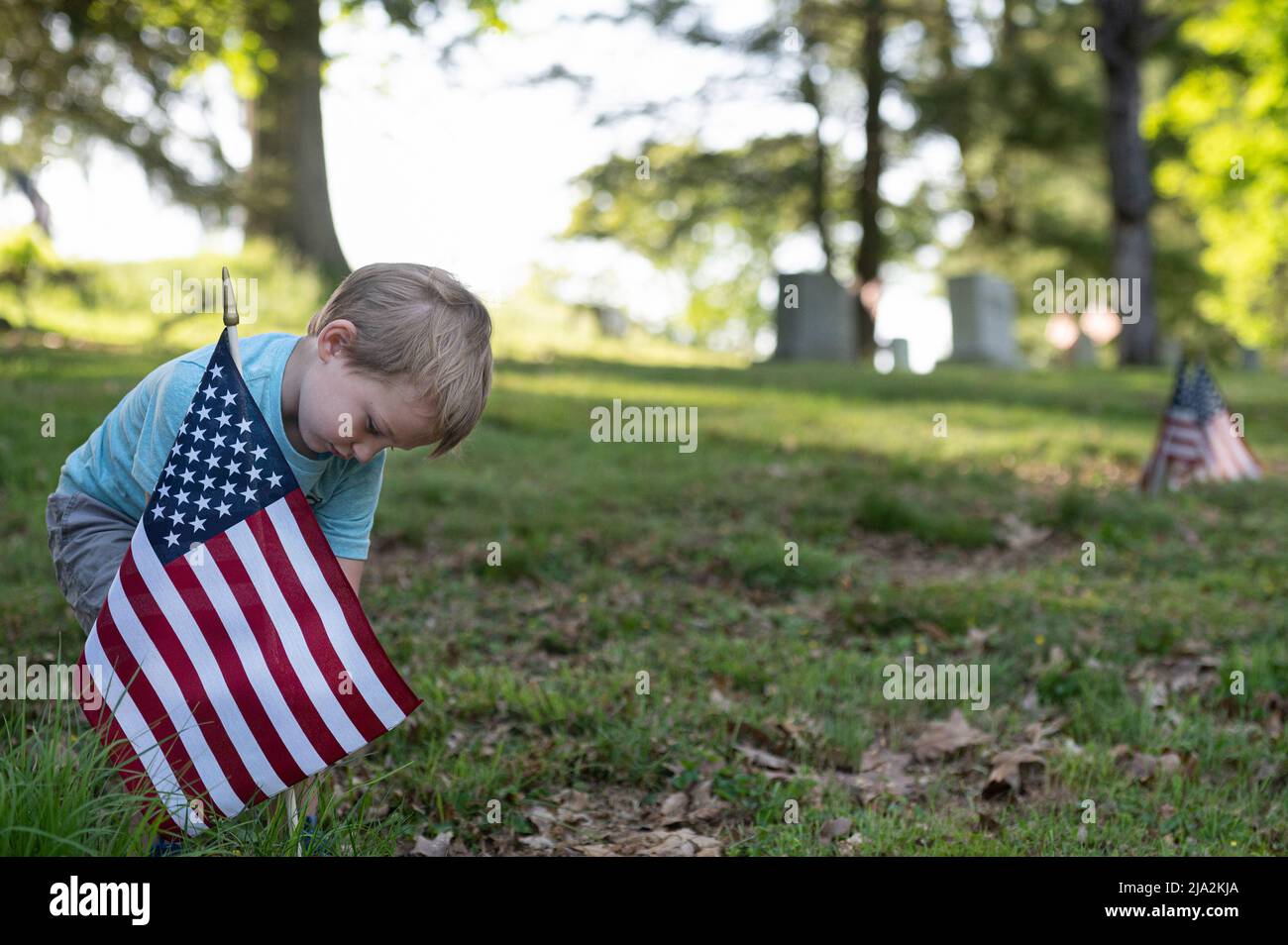 Dallas, Stati Uniti. 25th maggio 2022. Un giovane ragazzo ha posto una bandiera alla tomba di un veterano della seconda guerra mondiale. I membri della Legione americana, dei Boy Scouts e dei Girl Scouts hanno sostituito le bandiere tattered in tutti i cimiteri in preparazione alla festa del Memorial Day. (Foto di Aimee Dilger/SOPA Images/Sipa USA) Credit: Sipa USA/Alamy Live News Foto Stock