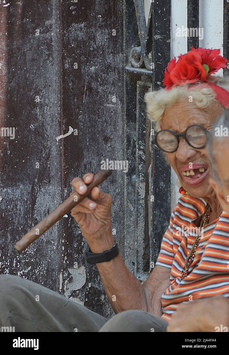 Vecchia donna cubana con lacune dentali che fumano un sigaro grande, Plaza Cattedrale, storico centro storico di l'Avana, Cuba, Caraibi Foto Stock