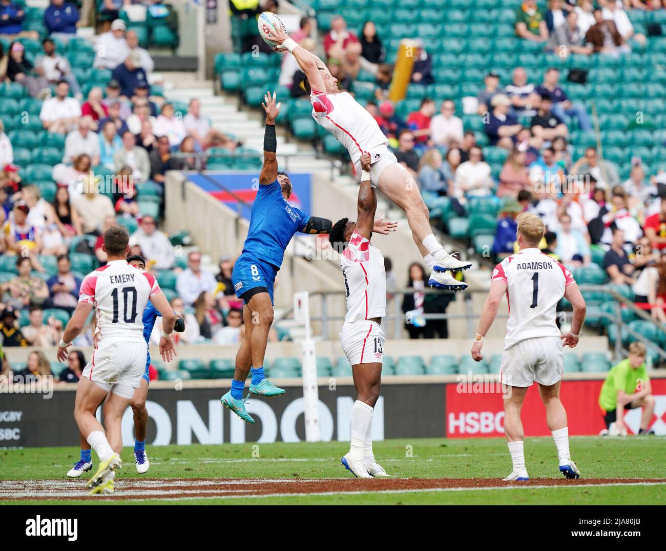 La VAA Apelu Maliko di Samoa (al centro a sinistra) cerca di allontanare la palla da Alex Davis (al centro) in Inghilterra, tenuto in alto dal compagno di squadra API Bavadra (al centro in basso) durante la partita 24 della HSBC World Rugby Sevens Series al Twickenham Stadium di Londra. Data foto: Sabato 28 maggio 2022. Foto Stock