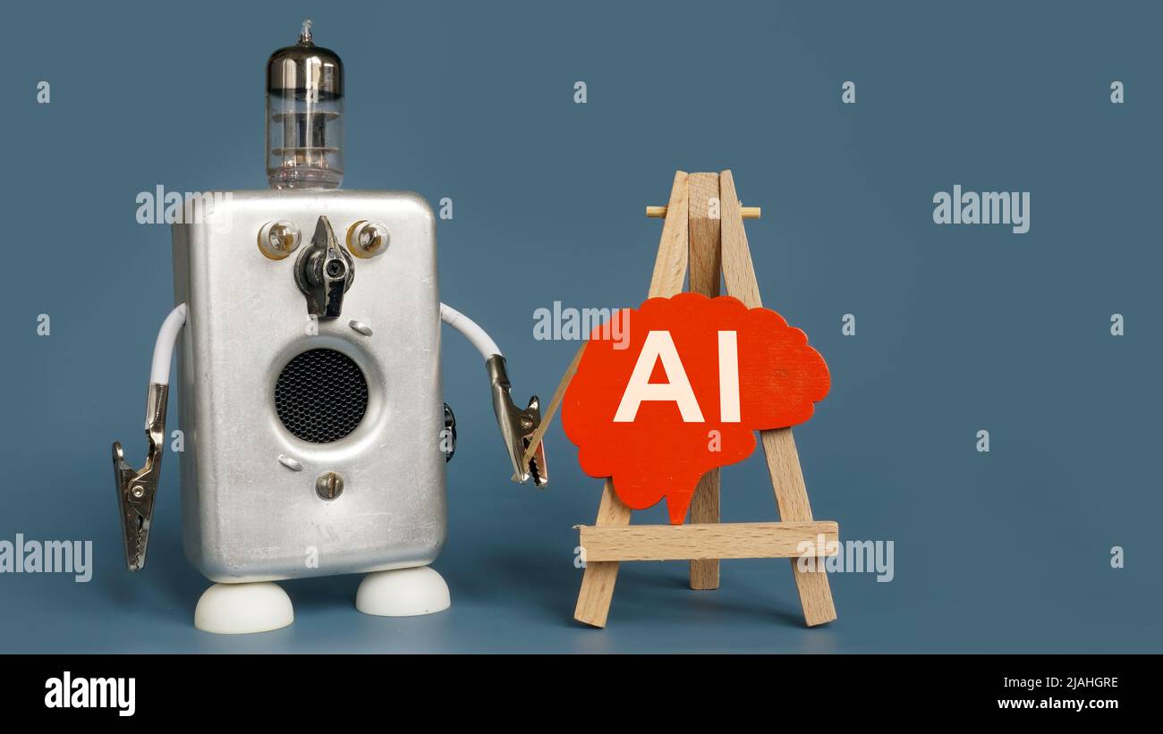 Il robot punta al cervello con l'iscrizione ai. Foto Stock