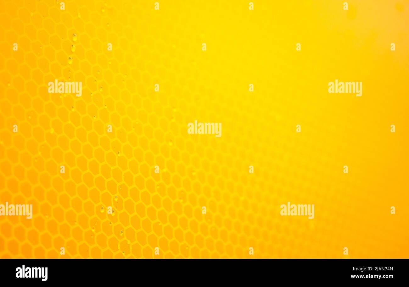 Arancione chiaro brillante nido d'ape astratto morbido sfondo semplice texture, sfondo giallo, carta da parati liscia, profondità di campo bassa, full frame. Tecnologia Foto Stock