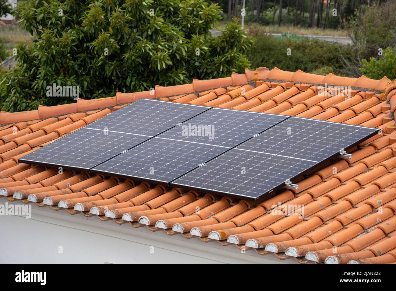 Tre pannelli solari fotovoltaici sul tetto di una casa Foto Stock