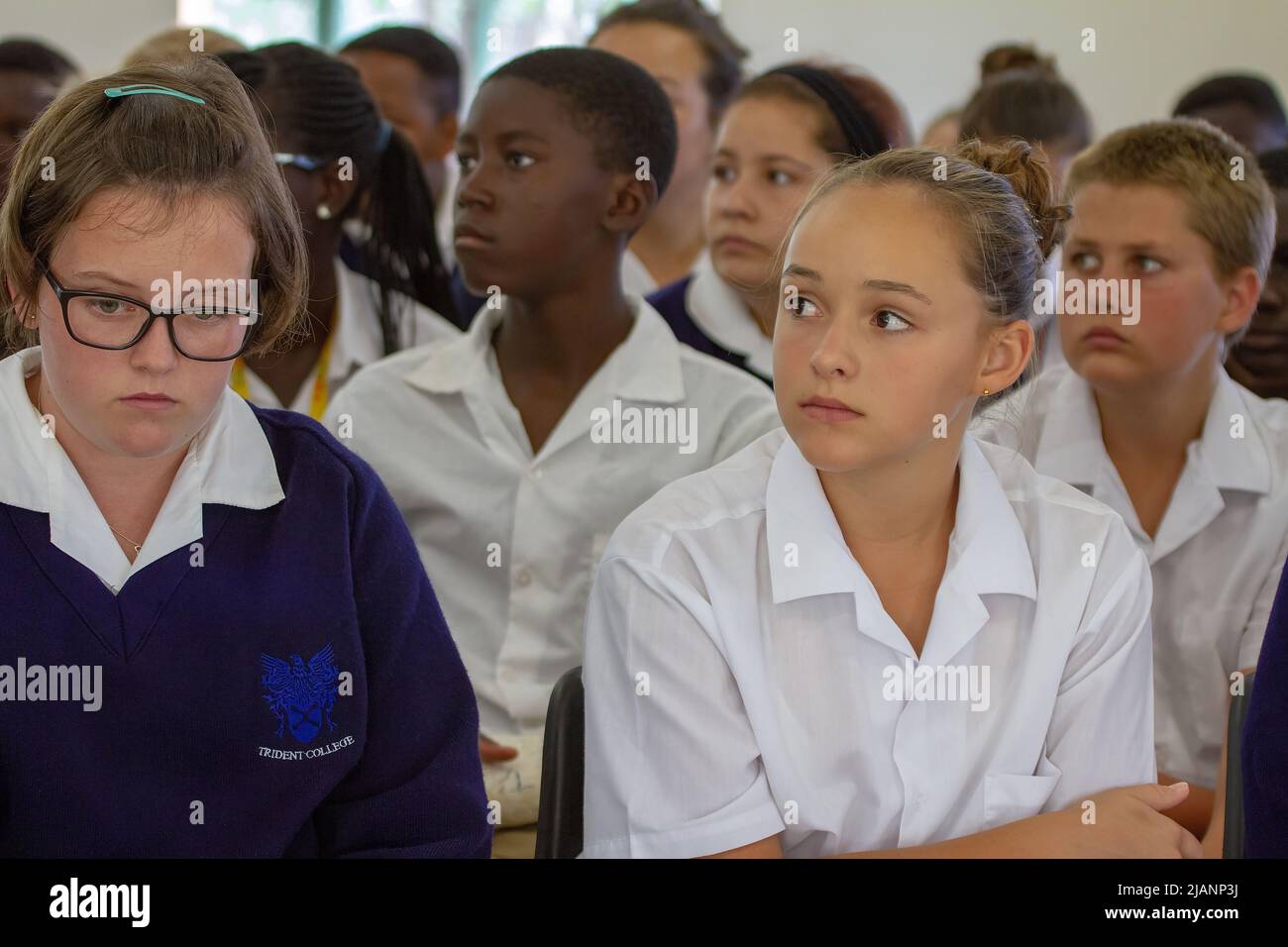 Studenti zambiani del Trident College Solwezi seduti in aula scolastica, espressioni contemplative Foto Stock