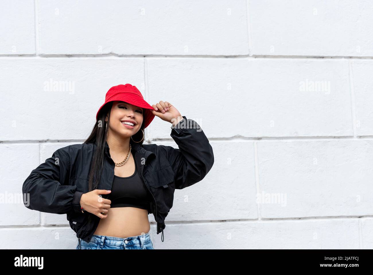 Giovane donna latina hip hop ballando in strada con un cappello rosso, Panama, America Centrale - foto di scorta Foto Stock