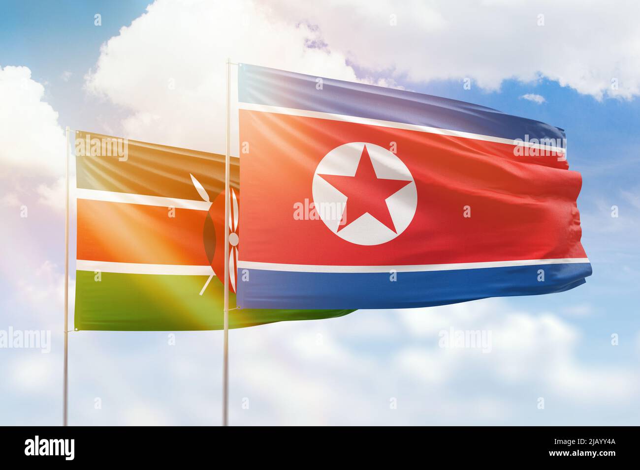 Cielo azzurro soleggiato e bandiere della corea del Nord e del kenya Foto Stock