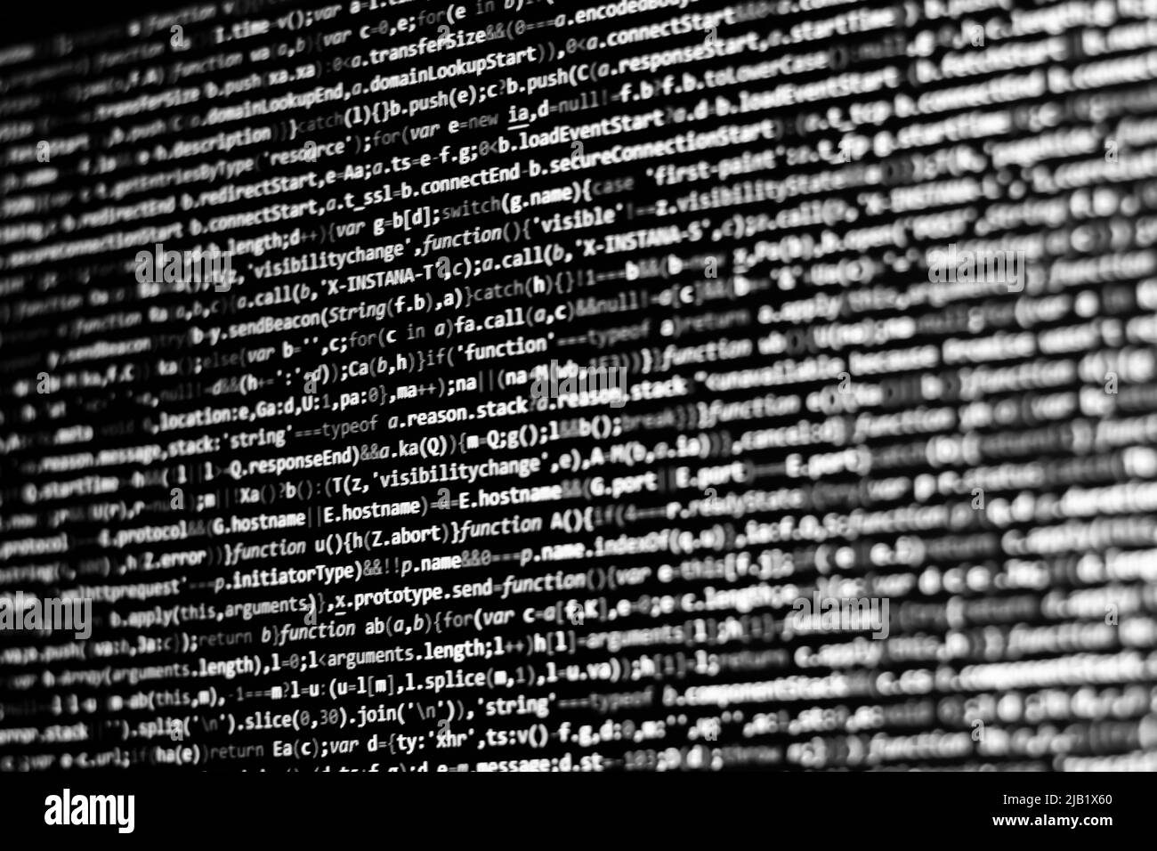 Sfondo del codice in bianco e nero. Codice javascript sullo schermo del computer Foto Stock