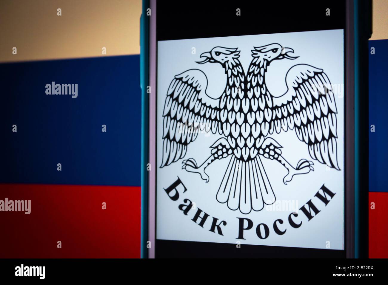 Kumamoto, GIAPPONE - Mar 1 2022 : un telefono visualizza un logo della Banca Centrale della Federazione Russa su una bandiera russa di colore scuro Foto Stock