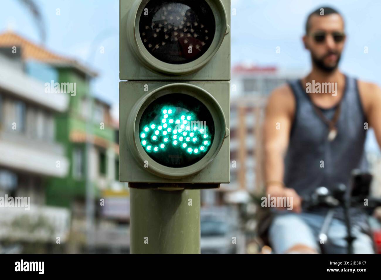 Semaforo verde per biciclette con ciclista sullo sfondo. Foto Stock