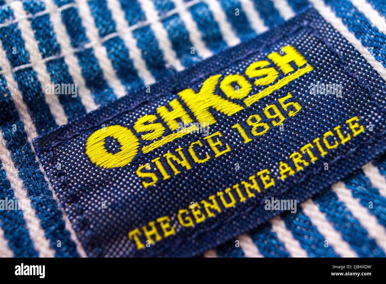 Il marchio di Oshkosh sulle sue tute a righe in hickory. Oshkosh B'gosh è un'azienda di abbigliamento statunitense fondata a Oshkosh, Wisconsin, nel 1895. Foto Stock