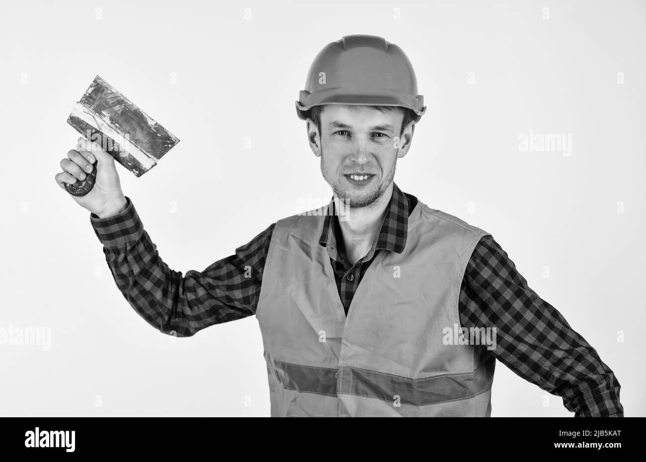 Stucchi uomo con utensili indossare un elmetto protettivo, concetto di lavoratore ospite Foto Stock