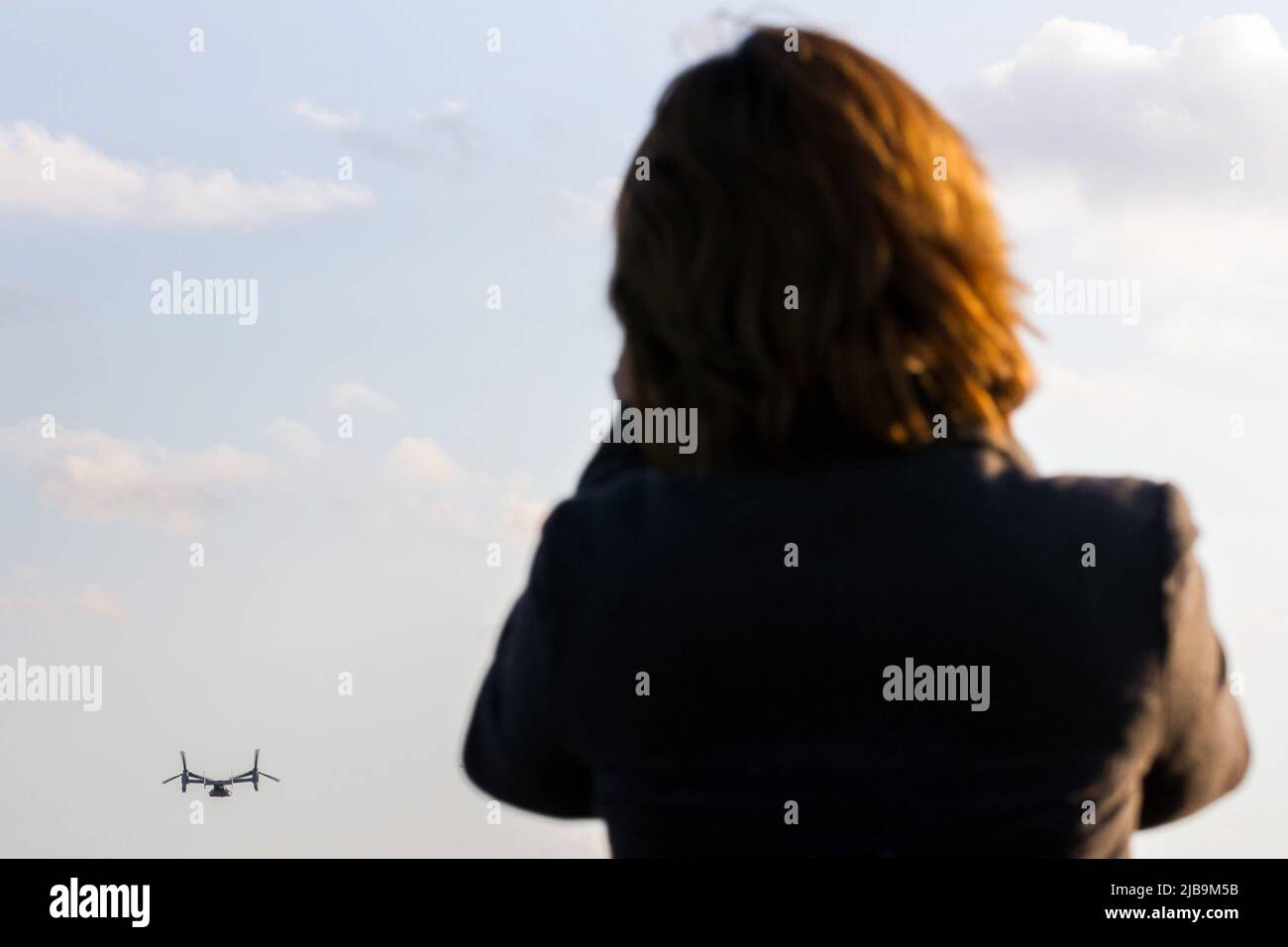 Una donna giapponese guarda il controverso Bell Boeing V22 Osprey Tilt-Rotor aereo con la Marina degli Stati Uniti, decollo dalla Naval Air Facility Atsugi a Yamato, Kanagawa. Foto Stock