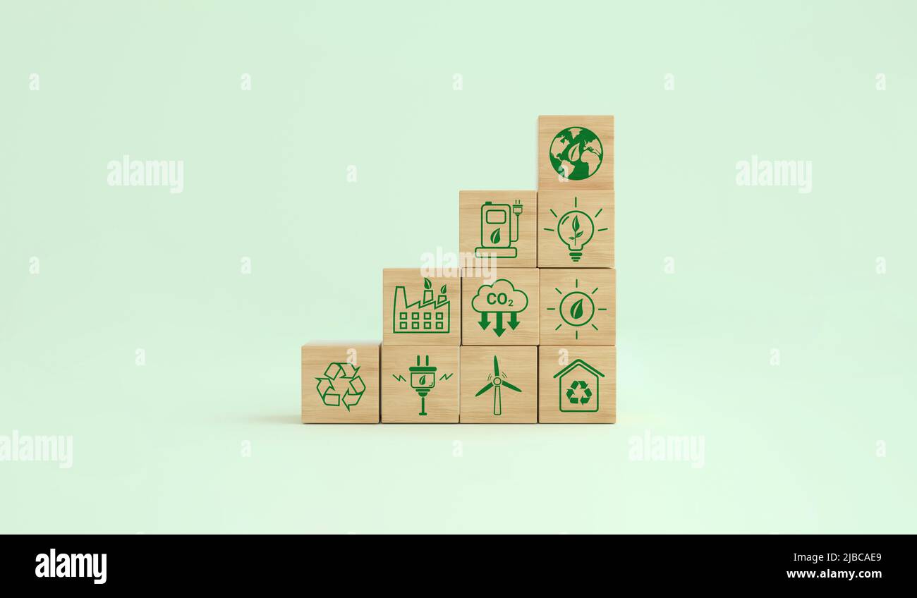 Simboli ecologici a impronta di carbonio su un cubo di legno. Energie alternative per salvare il pianeta. Concetto ambientale, cambiamento climatico. 3D rendering. Foto Stock