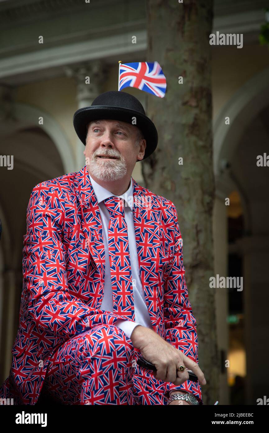 Londra, Regno Unito. 5th giugno 2022. Uno spettatore vestito in un'Unione jack abiti aspetta la sfilata per passare. Il Platinum Jubilee Pageant si tiene nel centro di Londra per celebrare i 70 anni di sua Maestà sul trono. La sfilata del 3km è condotta dalla vettura di stato d'oro, una carrozza di 260 anni che portò la Regina da e per la sua incoronazione nel 1953. Credit: Kiki Streitberger / Alamy Live News Foto Stock