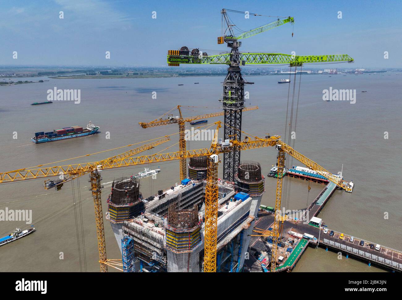 TAIZHOU, CINA - 7 GIUGNO 2022 - i lavoratori effettuano un'operazione di gru di prova per la torre w1000-450 nel sito di costruzione della brid del fiume CHANGTAI Yangtze Foto Stock
