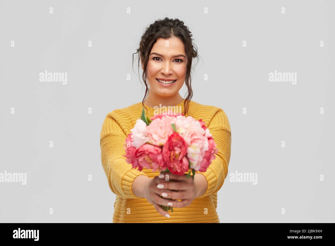 felice sorridente giovane donna con mazzo di fiori Foto Stock