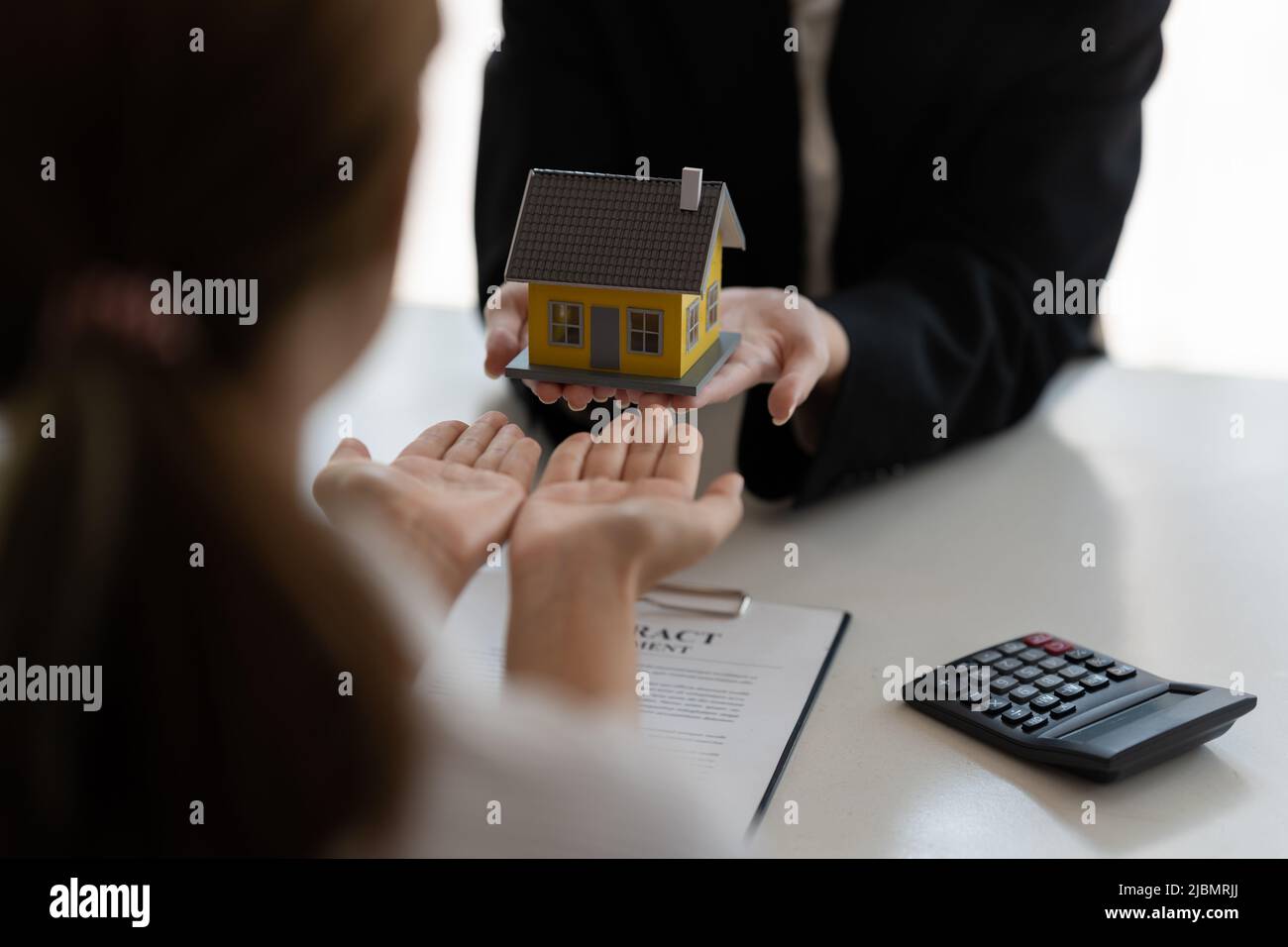 Commercio domestico e del bene immobile. Agente immobiliare che dà le chiavi al proprietario della donna della casa. Foto Stock