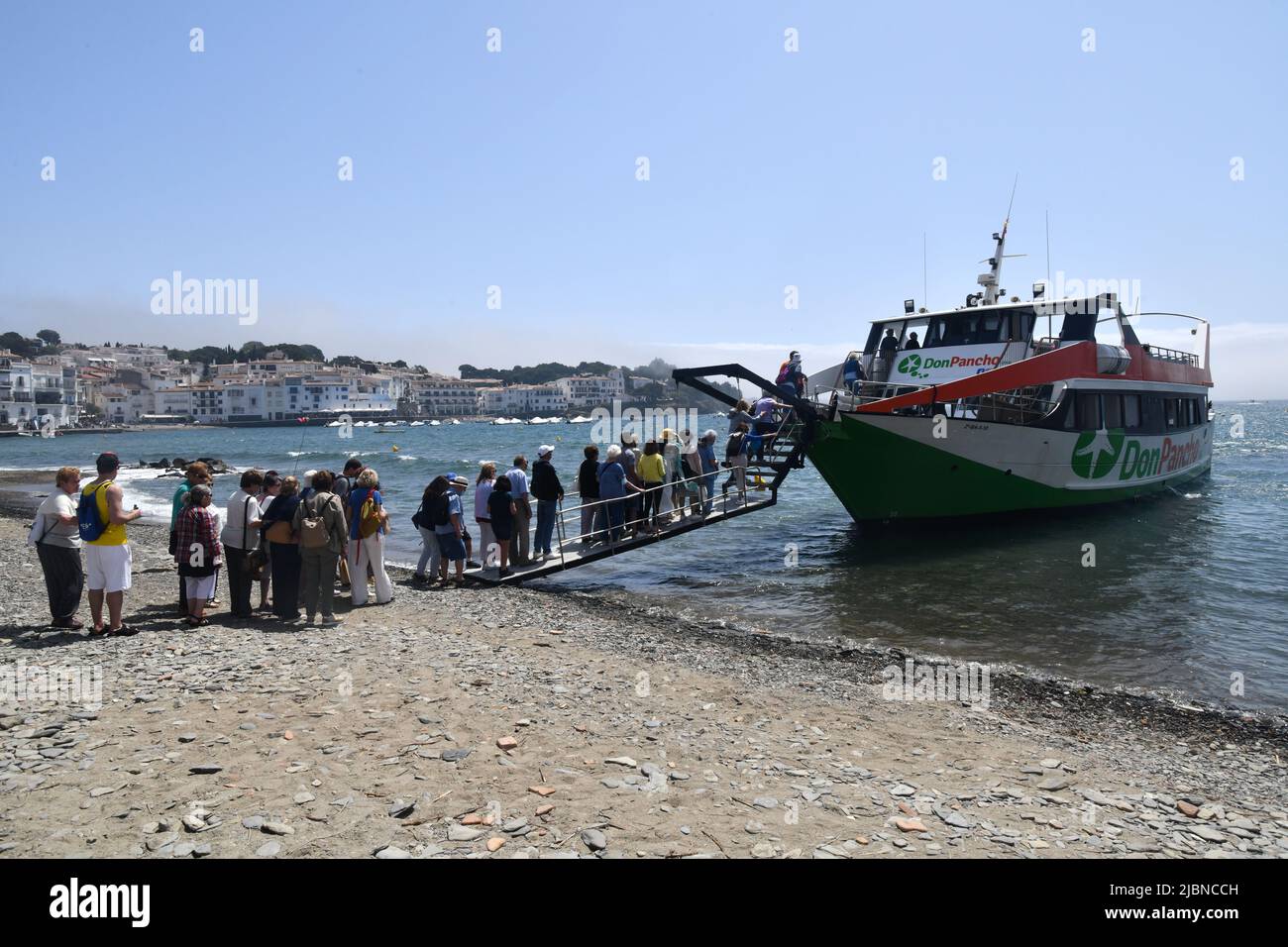 I turisti che si accaparrano a bordo di una barca a Cadaques una città spagnola nella Alt Empordà comarca, in provincia di Girona, Catalogna, Spagna. Foto Stock