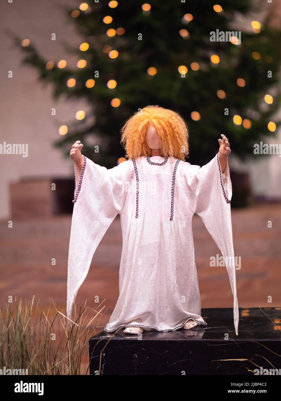 Amriswil, Svizzera - 25 dicembre 2021: La figura di Natale di un angelo nella chiesa e l'albero di natale Foto Stock