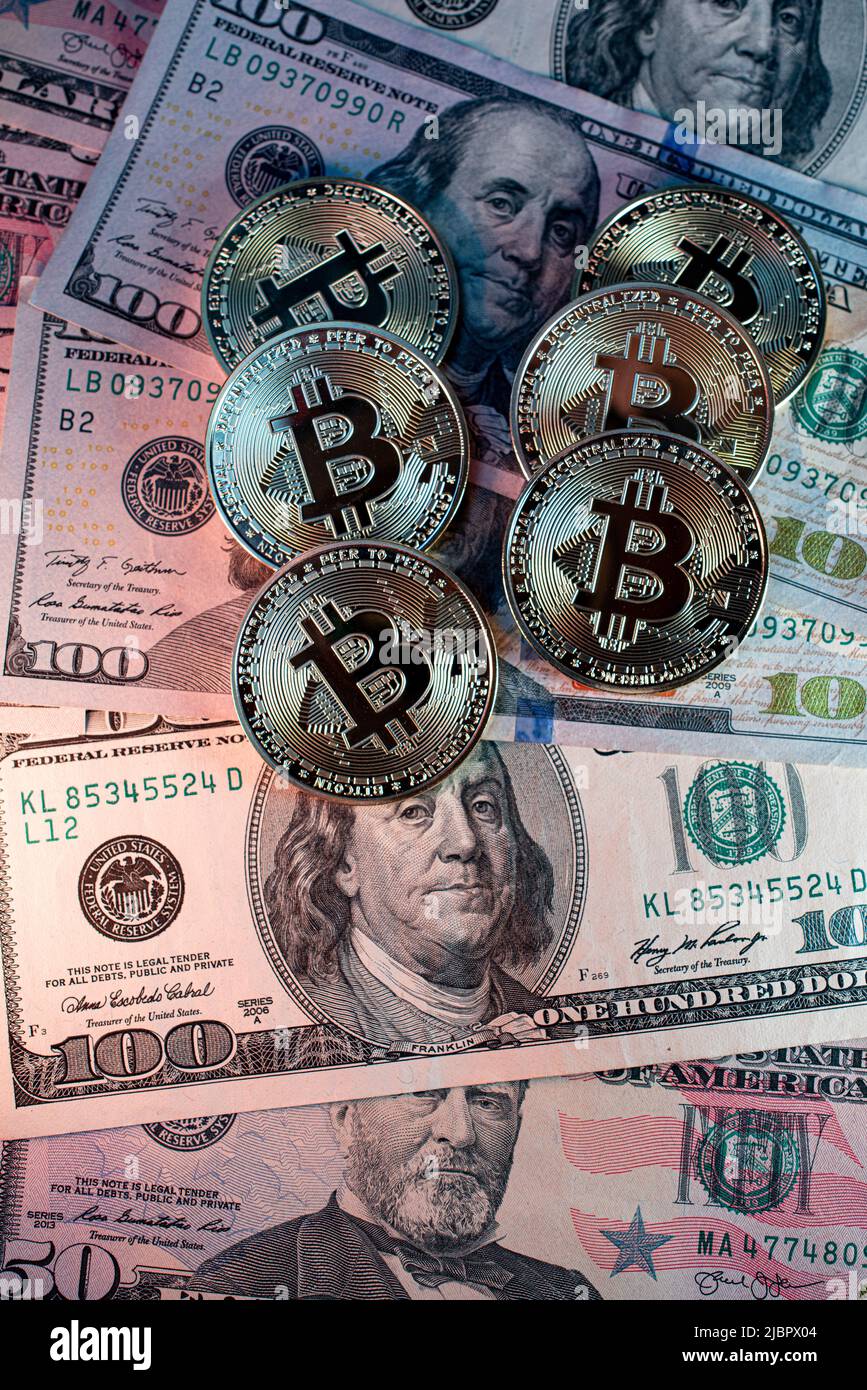 Monete metalliche lucide bitcoin cripto valuta su banconote in dollari statunitensi. Concetto di moneta decentralizzata elettronica. Foto Stock