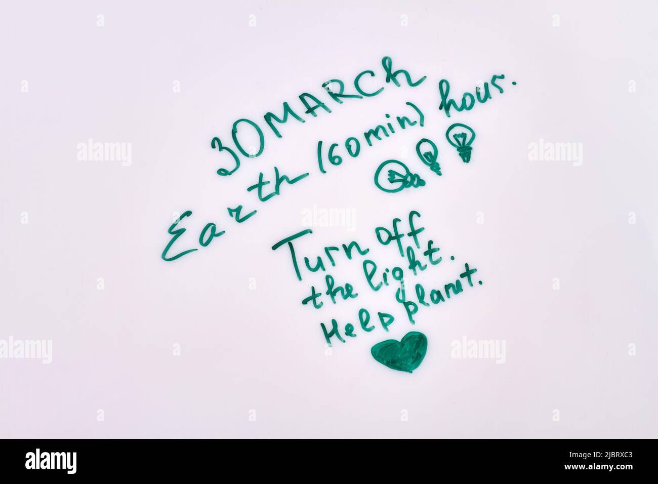 30 marzo ora di terra. Spegnere la plannet di risparmio luce. Scrittura a mano su sfondo bianco. Foto Stock
