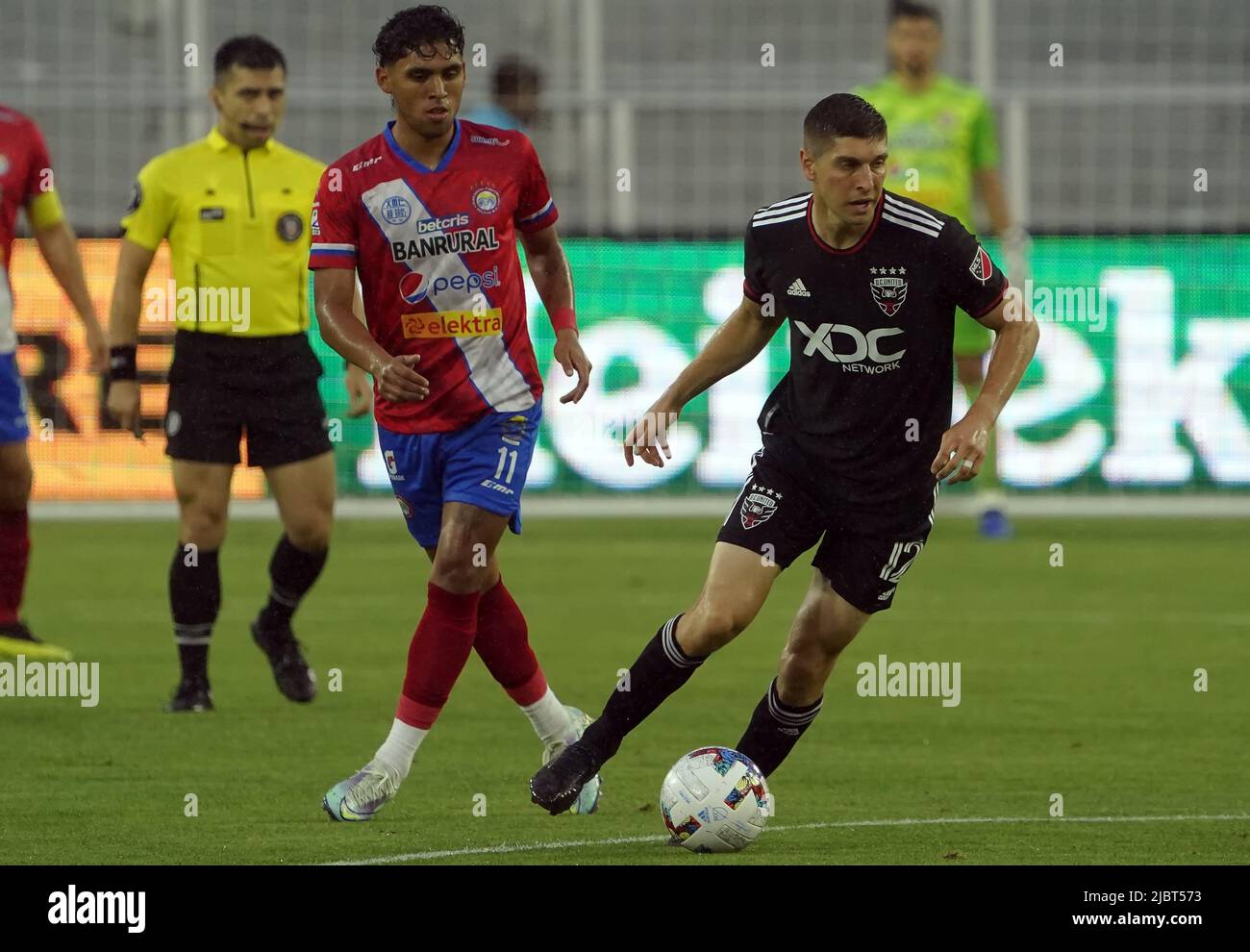 WASHINGTON, DC, USA - 07 GIUGNO 2022: Il centrocampista della DC United Drew Skundrich (12) si allontana da Xelaju in avanti Cristian Castillo (11) durante una partita della Capital Cup tra D.C United (USA) e Xelaju (GUA) il 07 2022 giugno, presso Audi Field, a Washington, DC. (Foto di Tony Quinn-Alamy Live News) Foto Stock