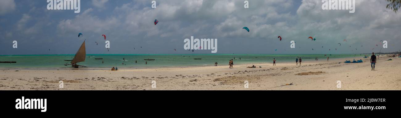 Zanzibar, Tanzania - Jan, 2021: Una tradizionale nave da sambuco a vela con una vela bianca sulle acque blu dell'oceano Indiano presso la spiaggia di surf a Paje, Foto Stock