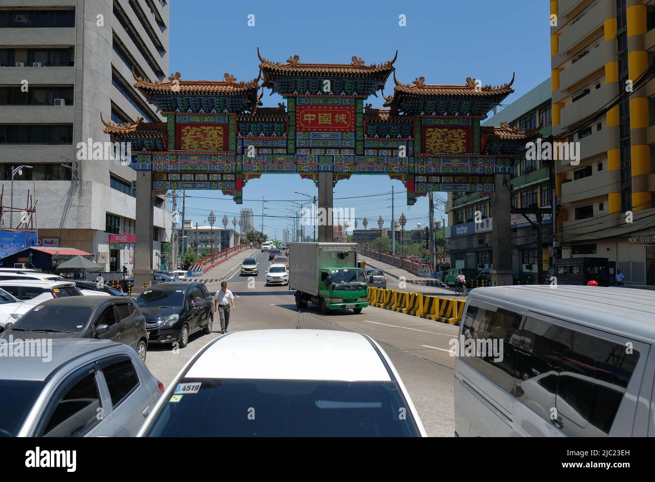 Manila, Filippine: Auto che passano da Jones Bridge attraverso il più grande Chinatown Arch del mondo (2015) nella più antica Chinatown del mondo, Binondo (1594). Foto Stock