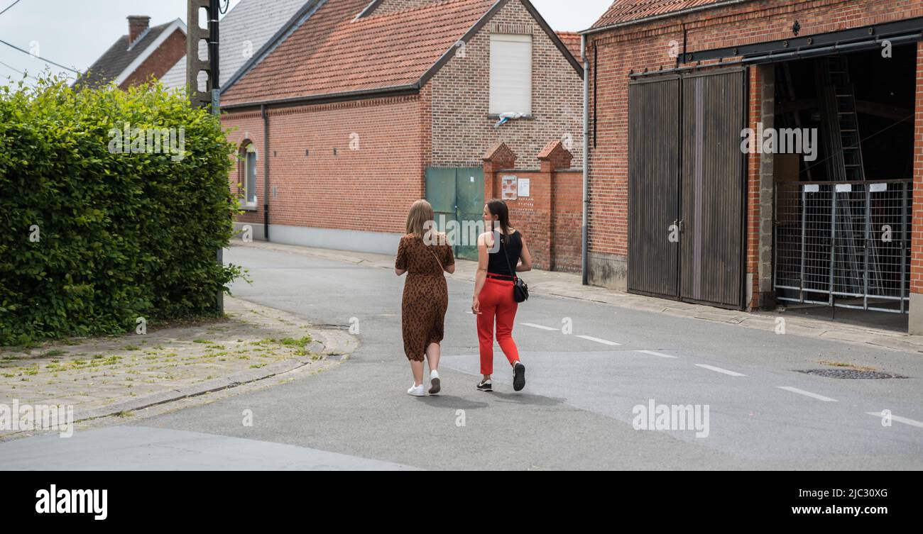 Lebbeke, Fiandre - Belgio - 05 25 2020 due ragazze attarctive delle scuole superiori di adolescenza che camminano attraverso il villaggio Foto Stock