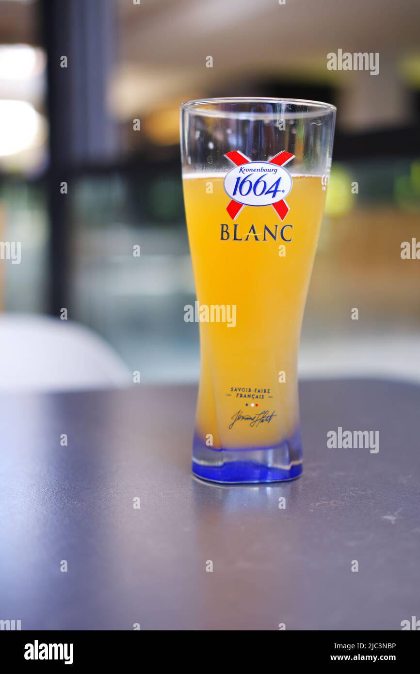 Birra francese '1664 Blanc' in vetro al tavolo in un ristorante Foto Stock