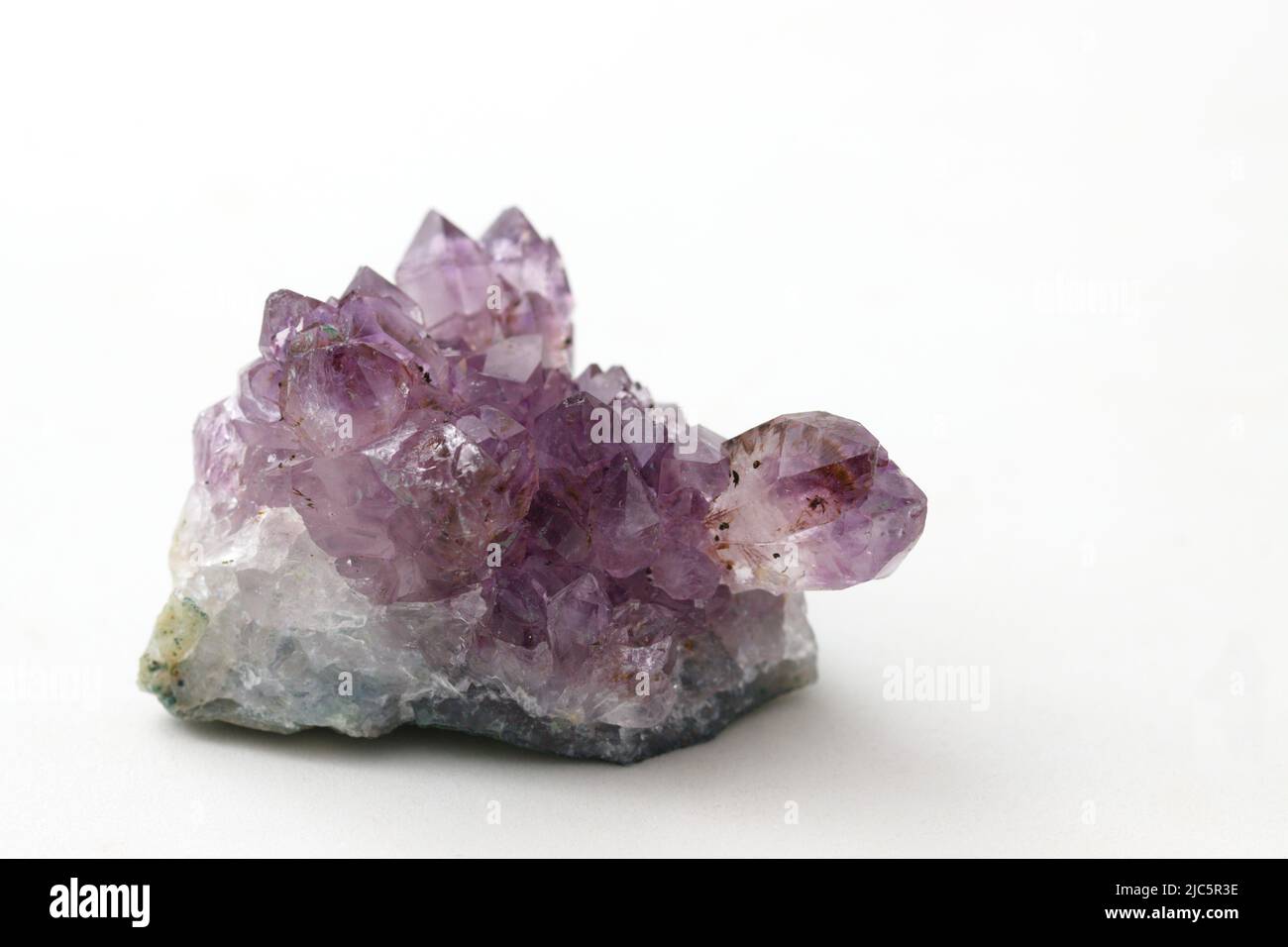 Particolare di un cristallo di ametista, varietà macrocristallina viola di quarzo isolato su sfondo bianco Foto Stock