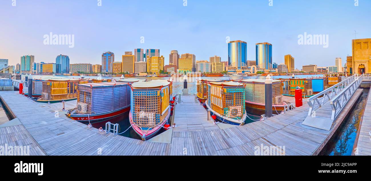 DUBAI, Emirati Arabi Uniti - 1 MARZO 2020: Panorama del vecchio molo di legno con piccole case-barche ormeggiate e le Torri Gemelle di Deira (Rolex Towers), visto sulla riva opposta, Foto Stock