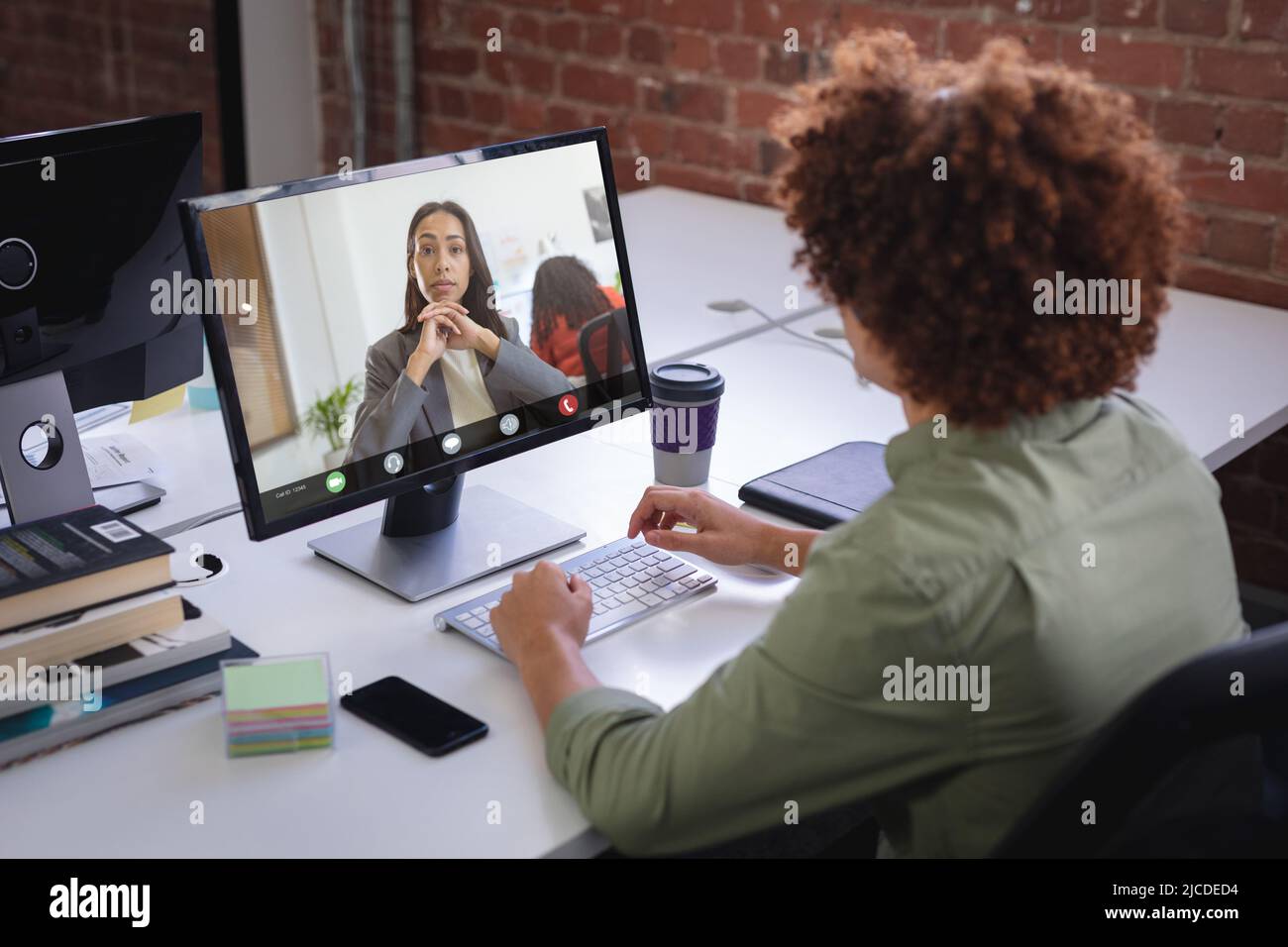 Un uomo d'affari biraciale e una donna d'affari afroamericana che si incontrano online tramite PC desktop Foto Stock
