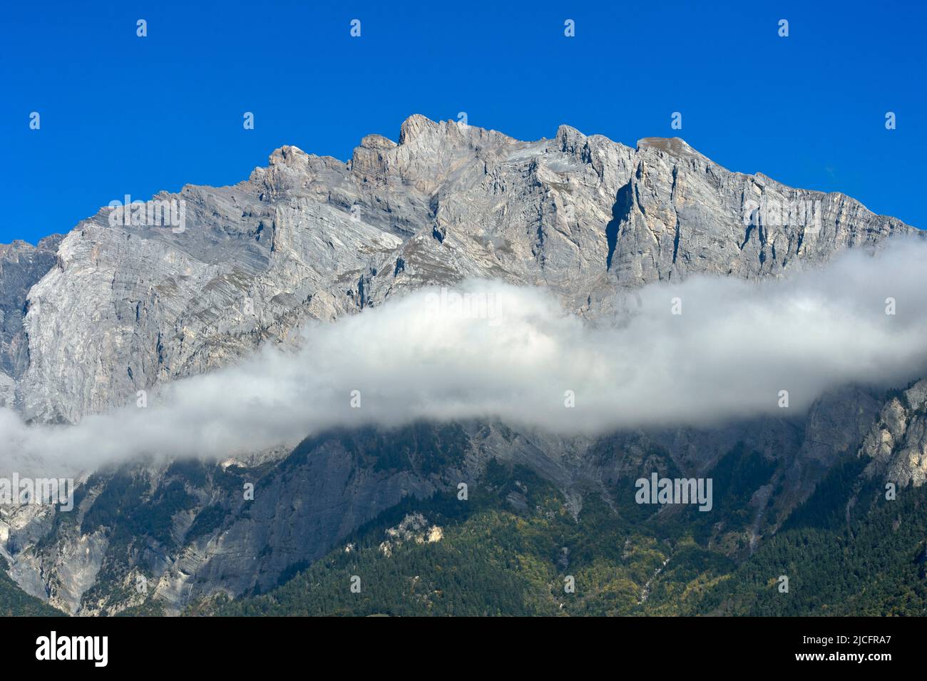 Nube banca di fronte al massiccio di montagna di Haut de Cry, Chamoson, Vallese, Svizzera Foto Stock