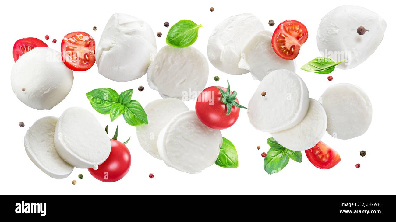 Fettine volanti di mozzarella con pomodori ciliegini, pepe e basilico isolato su sfondo bianco. Il concetto di prodotti alimentari biologici per Medit Foto Stock