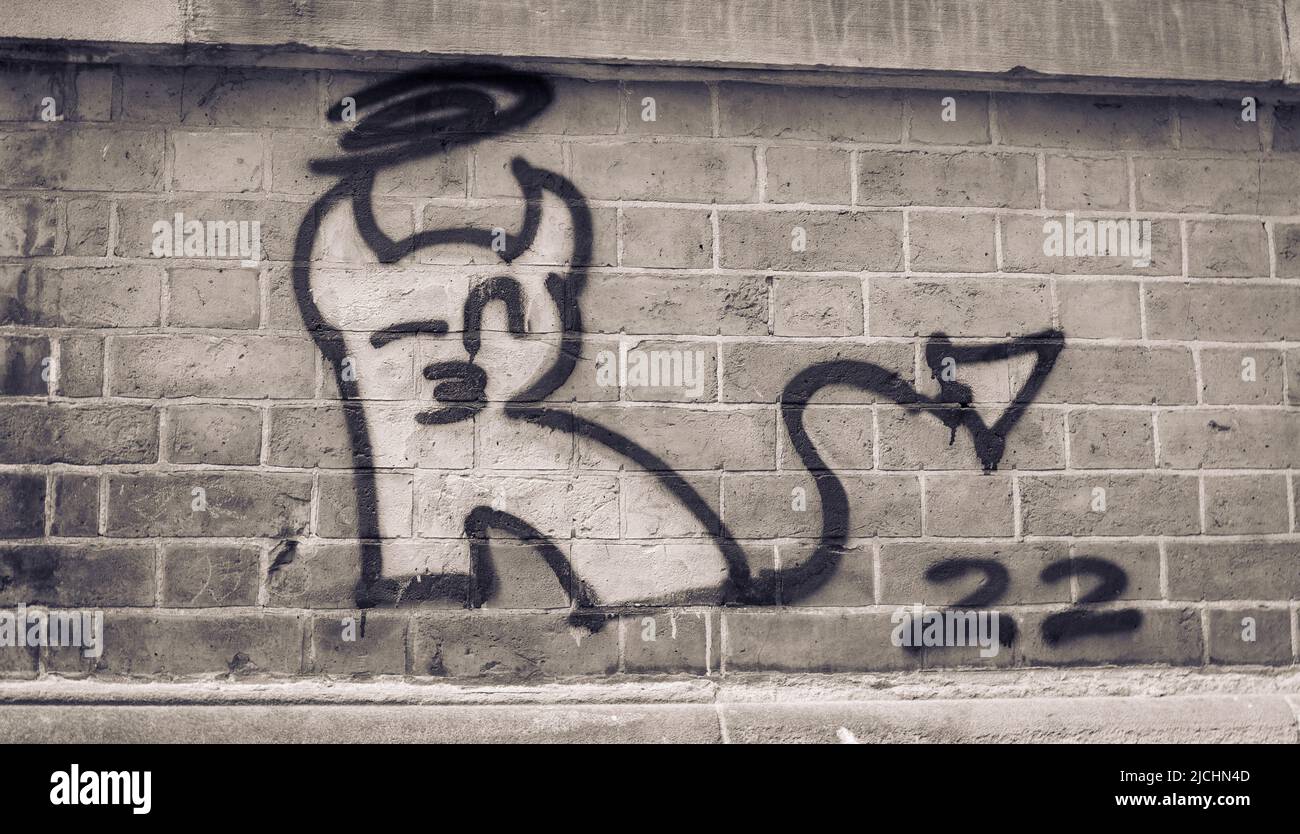 Un'immagine in bianco e nero di un diavolo graffiti sulle mura di una città del Regno Unito. Foto Stock