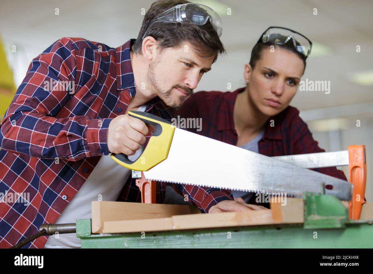 donna e uomo con una sega manuale a mano Foto stock - Alamy